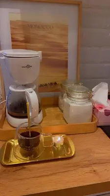 a tray with a cup of coffee on a table at Coumbis Faye in Brussels