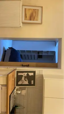 a bathroom with a mirror and a picture on the wall at Coumbis Faye in Brussels