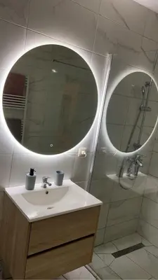 a bathroom with a sink and a large mirror at Coumbis Faye in Brussels