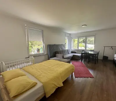 a bedroom with a bed and a couch and a table at Studio - simply living in Antwerp