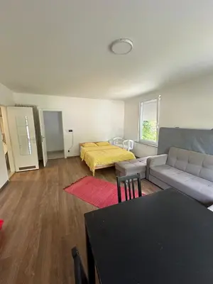 a living room with a couch and a bed at Studio - simply living in Antwerp