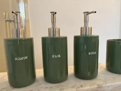 a group of three green bottles sitting on a table at Richard XIII in Antwerp