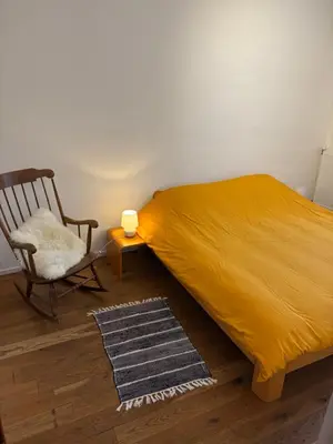 a bedroom with a bed and a chair and a lamp at Richard XIII in Antwerp