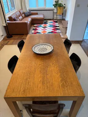 a wooden table with a plate on it in a living room at Richard XIII in Antwerp