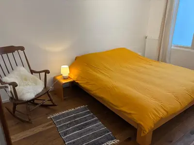 a bedroom with a bed and a chair and a lamp at Richard XIII in Antwerp