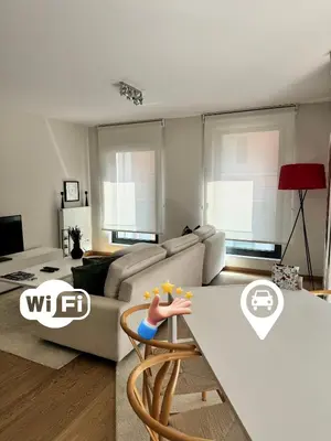 a living room with a couch and a table at Le Refuge Historique WIFI - Parking - Confort in Brussels