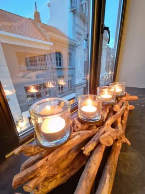 a group of candles on a table with a window at Cozy Room, Big City Adventures III in Ghent