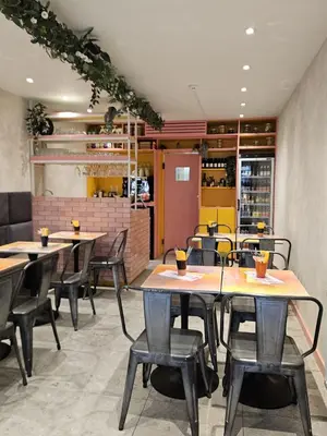 a restaurant with tables and chairs in a room at Cozy Room, Big City Adventures III in Ghent
