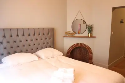 a bedroom with a large bed with a fireplace at Cozy Room in the Heart of Ghent I in Ghent