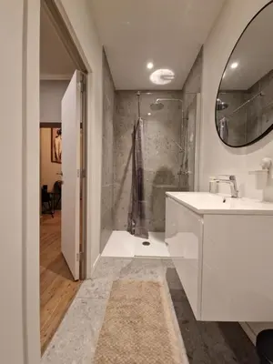 a bathroom with a white sink and a shower at Cozy Room in the Heart of Ghent I in Ghent