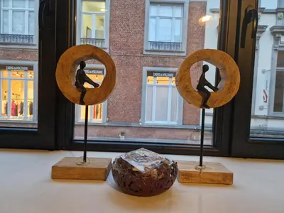 a group of three mirrors on display in front of a window at Charming Room in Ghent center II in Ghent