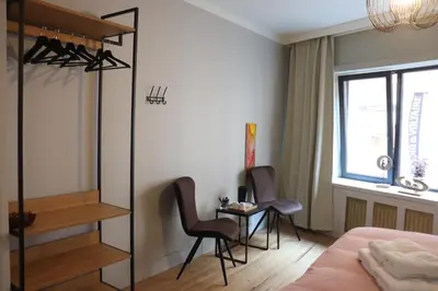a bedroom with a bed and two chairs and a table at Charming Room in Ghent center II in Ghent