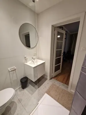 a white bathroom with a sink and a mirror at Charming Room in Ghent center II in Ghent