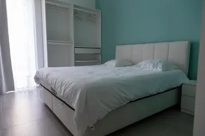 a bedroom with a large bed with a blue wall at Machelen in Machelen