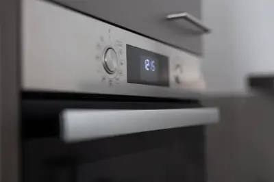 an oven with a clock on the front of it at Machelen in Machelen