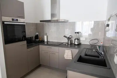 a kitchen with a sink and a counter top at Machelen in Machelen