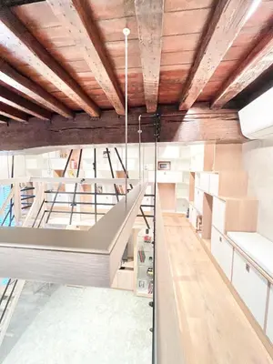 a room with wooden ceilings and a staircase with boxes at Luxury on Rue Haute in Brussels
