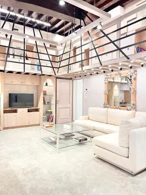 a living room with two white couches and a tv at Luxury on Rue Haute in Brussels