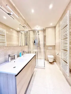 a bathroom with a sink and a shower and a toilet at Luxury on Rue Haute in Brussels