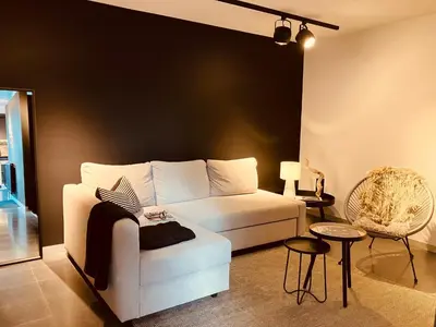 a living room with a white couch and a chair at The Studio in Antwerp