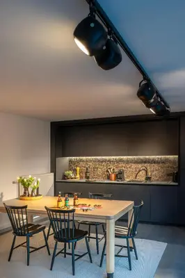 a kitchen with a wooden table and chairs in a room at The Studio in Antwerp
