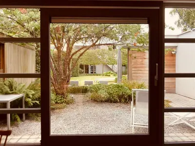 a window view of a garden from a house at The Studio in Antwerp