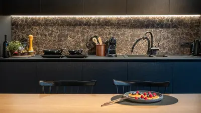 a kitchen with a bowl of fruit on a table at The Studio in Antwerp