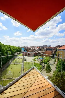 a balcony with a view of a park at Hôtel Belvue in Brussels
