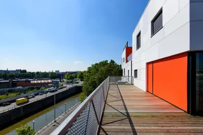 a walkway on the side of a building next to a river at Hôtel Belvue in Brussels
