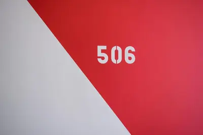 a red and white sign with the number at Hôtel Belvue in Brussels