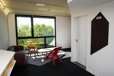 an office with a table and chairs and a window at Hôtel Belvue in Brussels