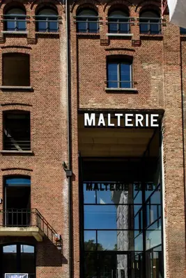 a large brick building with a market sign on it at Hôtel Belvue in Brussels