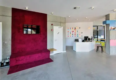 a large room with a red wall and a counter at Hôtel Belvue in Brussels