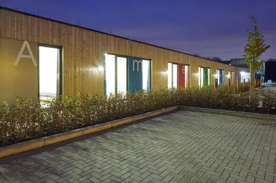 a row of windows on a building with plants at Bielebale Vakantiehuisjes in Brasschaat