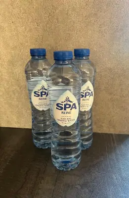 three bottles of water with labels on them at Appartement Brussels Expo in Strombeek-Bever