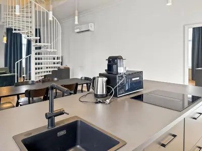 a kitchen counter with a sink and a microwave at Charming Ixelles Apartment Retreat in the Heart of Brussels in Brussels