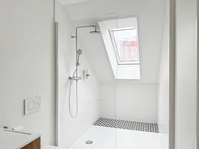 a white bathroom with a shower with a window at Charming Ixelles Apartment Retreat in the Heart of Brussels in Brussels