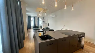 a kitchen with a counter and a sink in a room at Charming Ixelles Apartment Retreat in the Heart of Brussels in Brussels