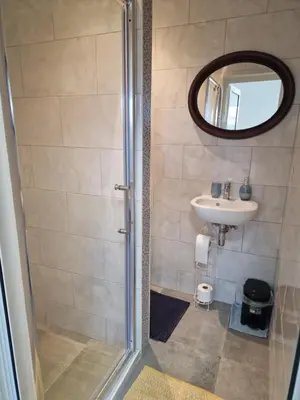 a bathroom with a shower and a sink at Nguetch & Gigi in Haaltert
