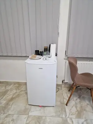 a white refrigerator and a chair in a room at Nguetch & Gigi in Haaltert