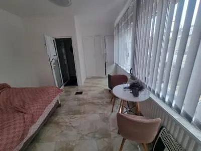 a room with a bed and a table and windows at Nguetch & Gigi in Haaltert