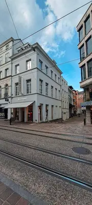 a large white building on the side of a street at Living Gent in Ghent
