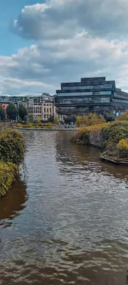 a river in front of a city with buildings at Living Gent in Ghent