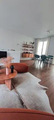 a living room with a couch and a table and chairs at Living Gent in Ghent