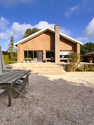 a brick house with a bench in front of it at B&B near Ghent in Merelbeke