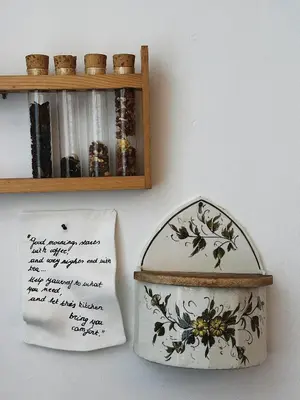 a box and a plate on a wall next to a shelf at Gent Gently apartment in center in Ghent