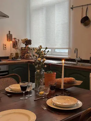 a table with a candle and plates and wine glasses at Gent Gently apartment in center in Ghent