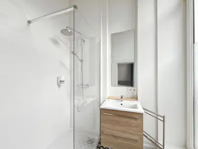 a white bathroom with a sink and a shower at self check in Ixelles Apartment Retreat in the Heart of Brussels in Brussels