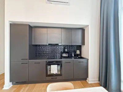 a kitchen with stainless steel appliances in a room at self check in Ixelles Apartment Retreat in the Heart of Brussels in Brussels