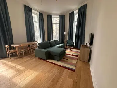 a living room with a couch and a table at self check in Ixelles Apartment Retreat in the Heart of Brussels in Brussels
